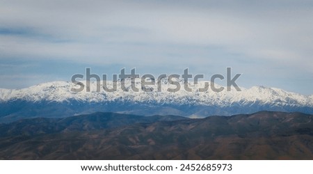 Snowy mountain panorama under the cloudy sky