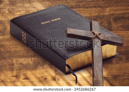 Holy Bible book, cross on light background