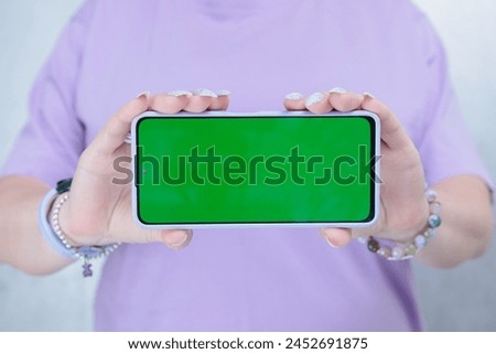 Woman's hands holding a large smartphone