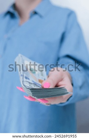 female hands holding American dollar paper bills
