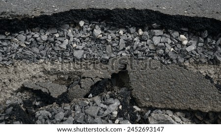 Asphalt road cross section in repair and reconstruction work. To show layer of surface and underground material. asphalt concrete, bitumen, soil, sand, rock, stone, crust, ground and earth. earthquake Royalty-Free Stock Photo #2452693147