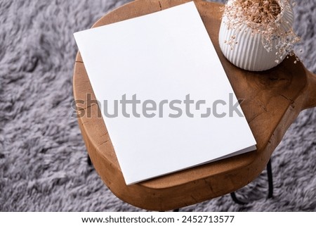 blank magazine mockup on coffee table with vase and grey rug