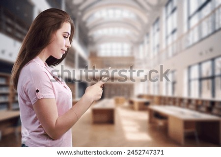 Girl student hold mobile phone in university Royalty-Free Stock Photo #2452747371