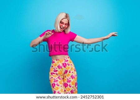 Photo portrait of lovely young lady touch sunglass summer dancing dressed stylish pink clothes isolated on blue color background