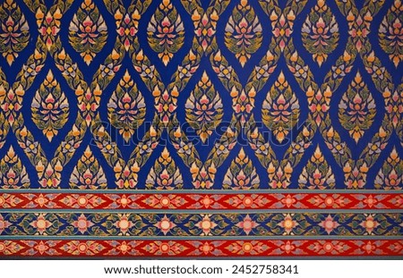 Thai style art ornament seamless pattern wallpaper, depict flower background, Red,blue,green and yellow design on the wall at temple in Thailand.