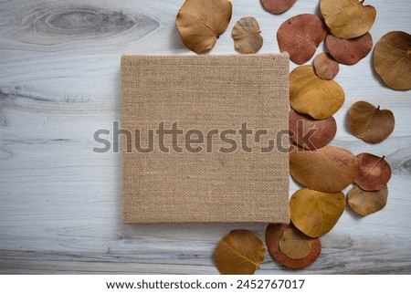 Blank square brown burlap canvas with autumn fall leaves no text concept mockup
