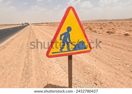 Warning Construction Road Sign in the Desert, Red and Yellow Construction Sign