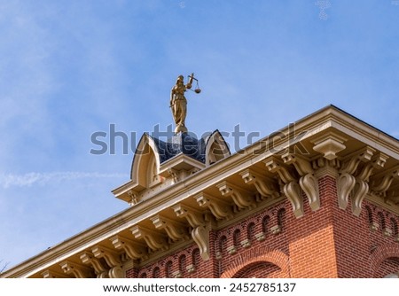 Lady Justice or Iustitia on the roof of the Delaware County Courthouse in Delaware, OH Royalty-Free Stock Photo #2452785137