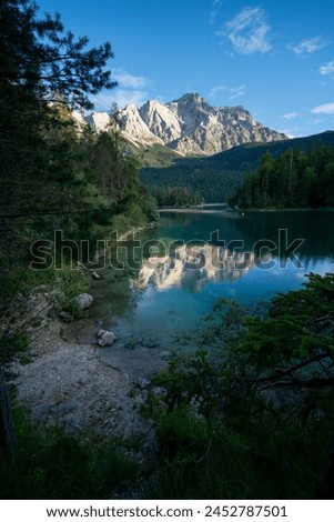 Lake eibsee at sunset with still water reflection