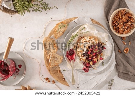 Baked camembert cheese served with the addition of red fruits jam. Top view. Flat layer Royalty-Free Stock Photo #2452805421