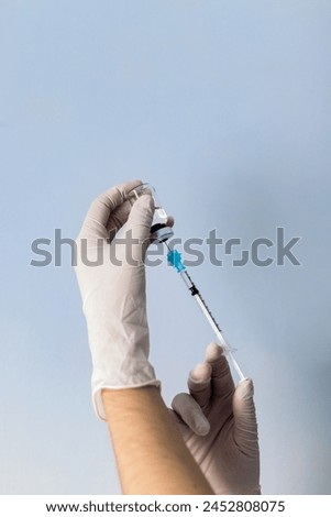 Hand holding syringe with vaccine. Vaccination concept. Covid-19