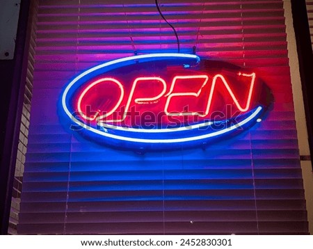 Neon open signage in a restaurant storefront window display on Rideau Street in downtown Ottawa Ontario Canada.