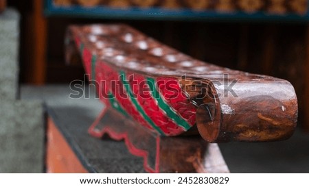 A unique traditional game typical of Indonesia called 'dakon' is made of wood and has holes