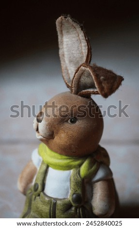 image of a cute cartoon show piece bunny with long ears in green and white dress, easter bunny
