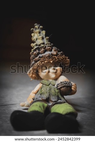 image of a cute cartoon show pieces with a big hat and nut in his hand in green dress and large boot, dwarf portrait, folklore