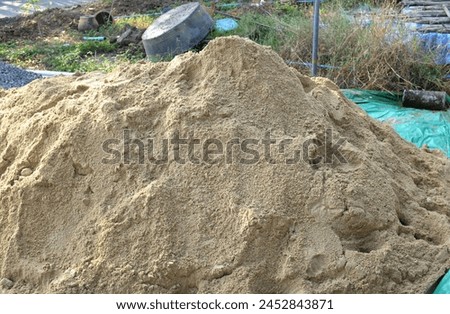 Pile of gravel or stone and sand in construction site.
Pile of fine sand for building the house Industrial object photo, close-up and selective focus.