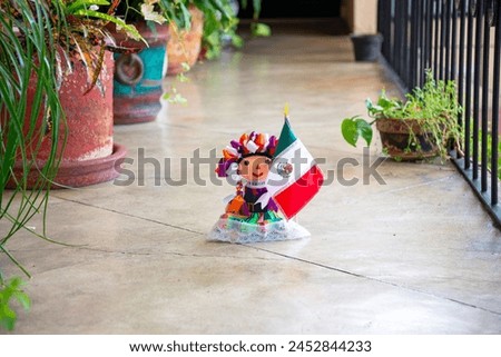 A Maria doll with Mexican flag, traditional decor on a serene patio