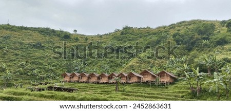 A row of wooden houses with a mountain background. A peaceful and scenic village scene, blending traditional architecture with natural beauty."