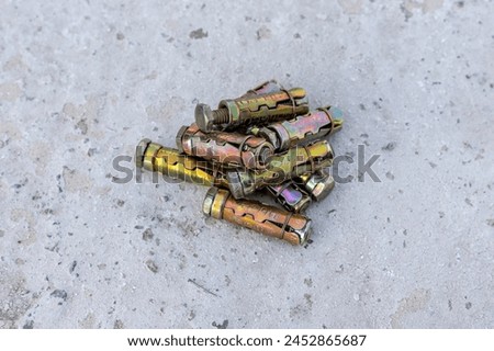 Sleeve anchor bolt or expansion bolt on a concrete background