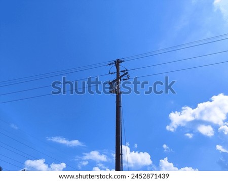 electric pole in the sky and clouds showing bright days
Format Foto