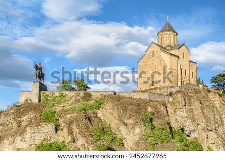 Awesome view of the Virgin Mary Assumption Church of Metekhi on the cliff over the Kura (Mtkvari) River in Tbilisi, Georgia. The Georgian Orthodox Christian church is a popular tourist attraction. Royalty-Free Stock Photo #2452877965