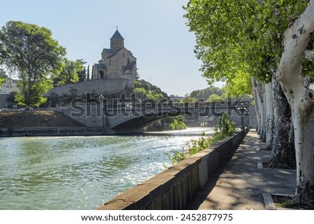 Awesome view of the Virgin Mary Assumption Church of Metekhi and the Metekhi Bridge over the Kura (Mtkvari) River in Old Town of Tbilisi, Georgia. Tbilisi is a popular tourist destination. Royalty-Free Stock Photo #2452877975