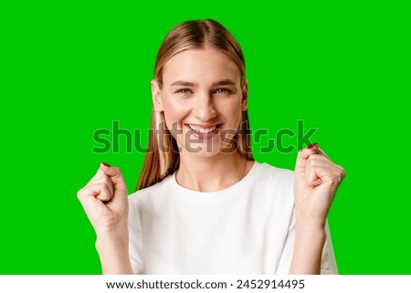 Young Woman Poses for Picture against green background.