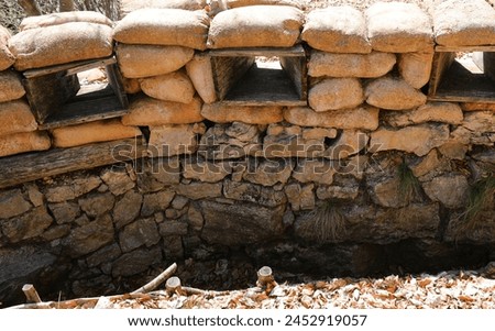 trench loophole on the war front line with many sandbags for army protection Royalty-Free Stock Photo #2452919057