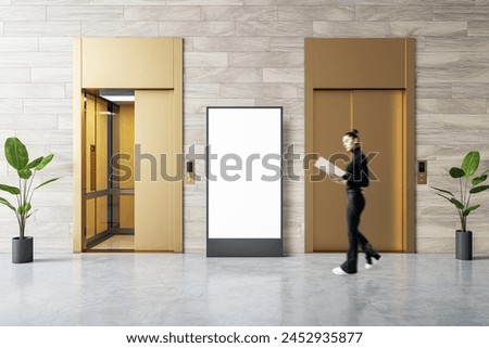 Professional woman walking past a mockup display in a corporate hallway