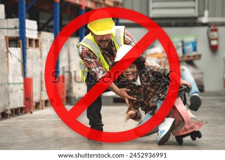 Dangerous, don't play in warehouses, prohibition sign superimposed over the image of African child boy wearing a hard hat and reflective vest playing cart with male worker in warehouse Royalty-Free Stock Photo #2452936991