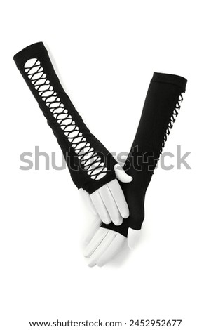 Close-up shot of a black long fingerless gloves. The pair of black openwork mittens is isolated on a white background. Front view. Royalty-Free Stock Photo #2452952677