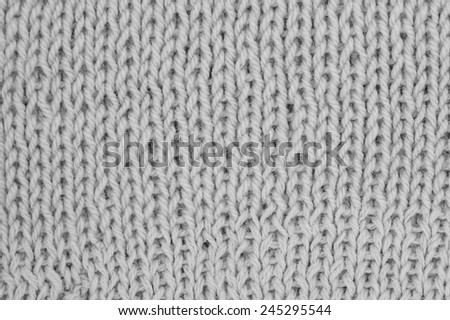 Knit woolen texture. Fabric grey background 