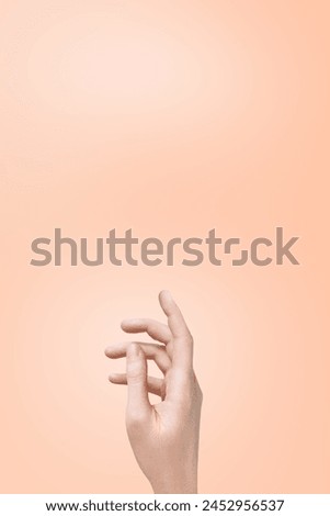 female hand of a Caucasian girl on a gentle background of peach fuzz, trend color of the year 2024. Display for advertising cosmetics. Vertical photo, copy space
