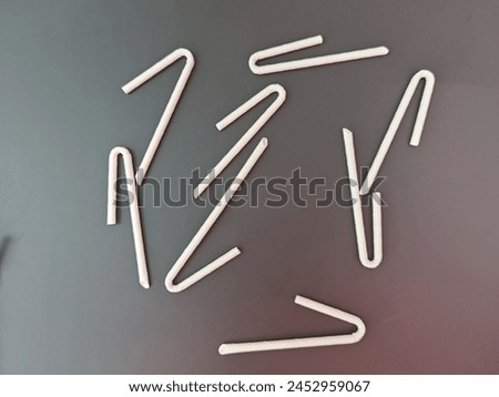 Disposable straw for use on the wooden table background. 