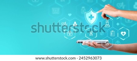 A hand interacting with medical icons projected over a smartphone against a blue background, symbolizing healthcare technology