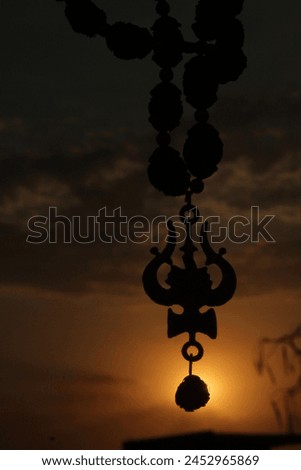 Lord Shiva Trishul with Sun set Royalty-Free Stock Photo #2452965869