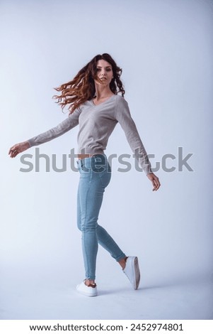 Portrait of a full-grown happy young beautiful girl on a white background smiling at the camera Royalty-Free Stock Photo #2452974801