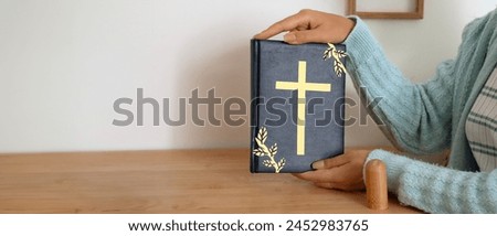 Young woman with Bible at home. Banner for design