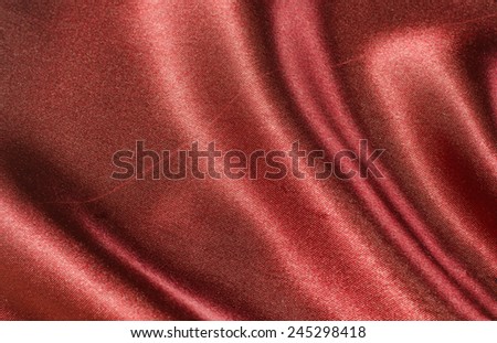 red satin silk fabric background Royalty-Free Stock Photo #245298418