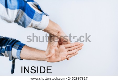 Hands gesturing the word INSIDE in sign language isolated
