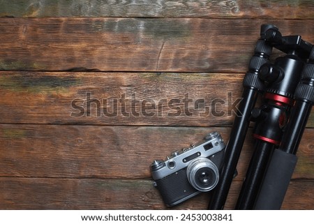 Photo studio equipment concept top view background with copy space. Photostudio led constant light sources and different light modifiers on the wooden table background. Royalty-Free Stock Photo #2453003841