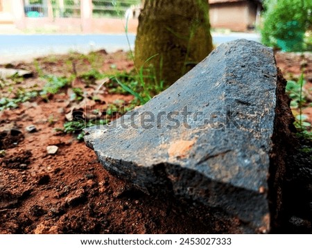 chunks of elephant rock in the yard of the house. One type of split stone that has strong and sturdy properties. Usually used as a basic material for building houses Royalty-Free Stock Photo #2453027333
