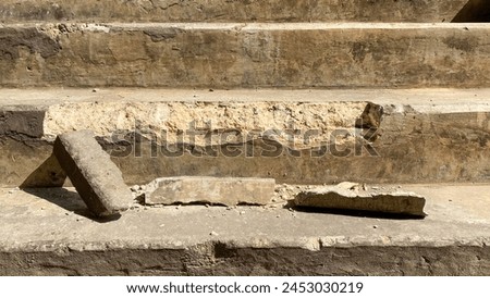 Cracked concrete stairs are a common sight in older buildings or those subjected to heavy use. These cracks can occur due to various reasons, including settling of the foundation or heavy impact. Royalty-Free Stock Photo #2453030219