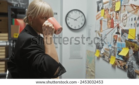 A blonde woman investigates crime at the police station, examining a board of clues while sipping coffee.