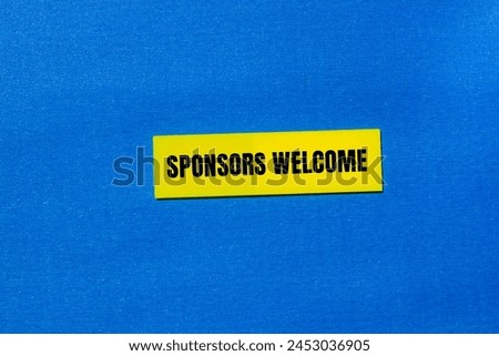 Sponsors welcome words written on yellow paper piece with blue background. Conceptual business symbol. Copy space.