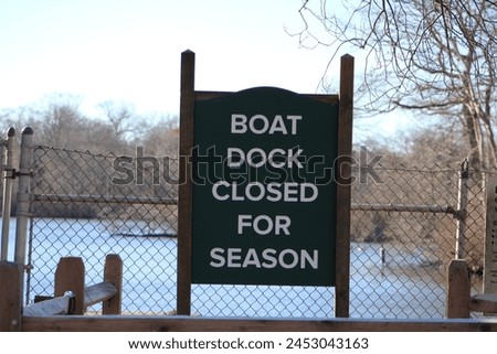 A sign that says "Boat Dock Closed for Season".