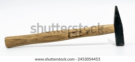 A photo of an old wooden hammer with a black head on a white background, taken from the side in a closeup.