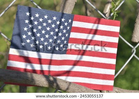 Closeup of an American flag on a fence