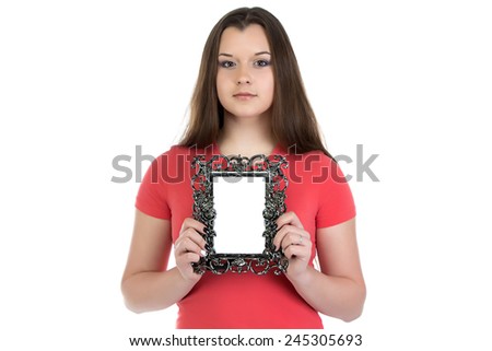 Portrait of teenage girl holding photo frame on white background