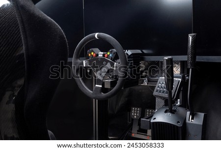 DIY high end simracing aluminum carbon fiber simulator rig for video game sim racing. Black CFK car bucket seat steering wheel shifter pedals and tripe screen setup on dark background